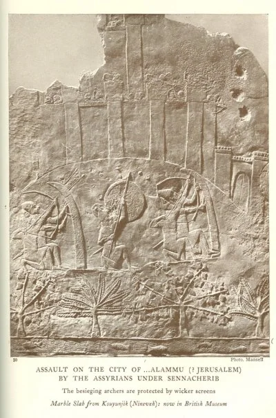 ASSAULT ON THE CITY OF . . .ALAMMU (? JERUSALEM) BY THE ASSYRIANS UNDER SENNACHERIB<br> The besieging archers are protected by wicker screens<br> <i>Marble Slab from Kouyunjik (Nineveh): now in British Museum</i>.<br> Photo. Mansell