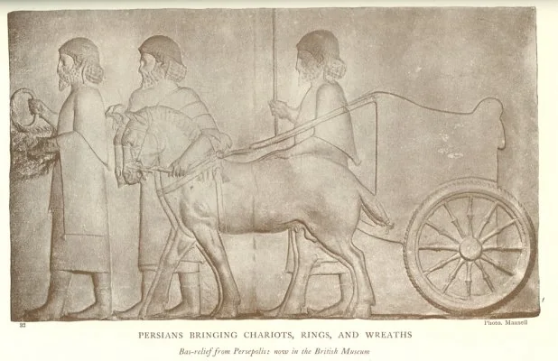 PERSIANS BRINGING CHARIOTS, RINGS, AND WREATHS<br> <i>Bas-relief from Persepolis: now in the British Museum</i>.<br> Photo. Mansell
